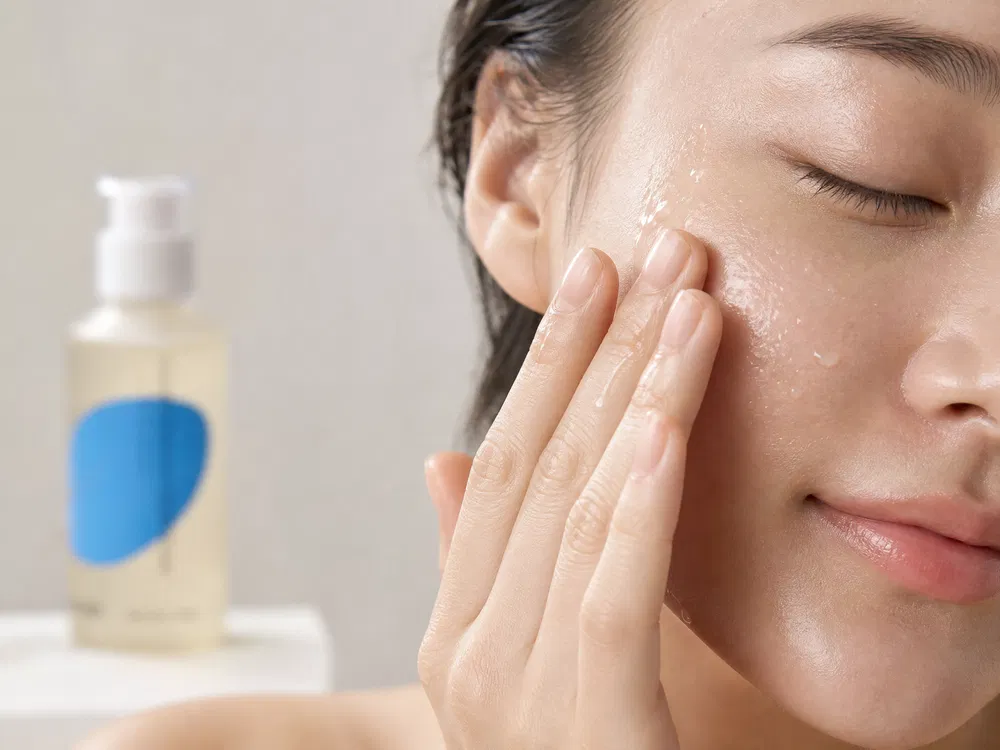 Patting hyaluronic toner into skin for hydration absorption