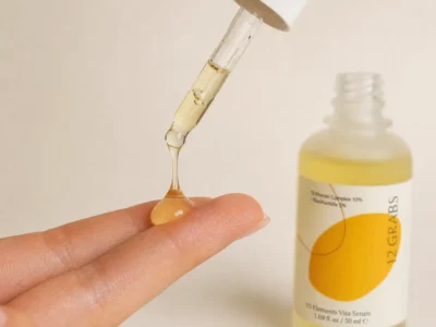 Vitamin C serum drop application showing golden liquid texture